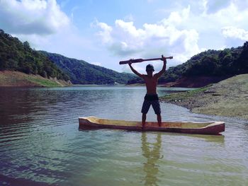 Full length of person standing on shore against sky