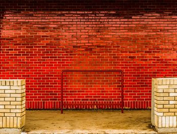 Red barn by brick wall