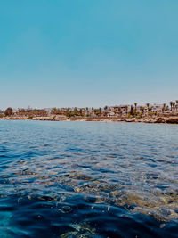 Scenic view of sea against clear blue sky