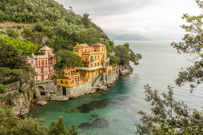 Scenic view of sea against buildings