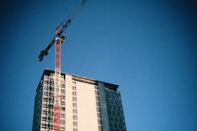 Low angle view of modern buildings against blue sky