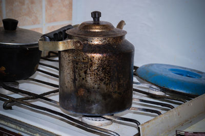 Close-up of rusty kettle on stove