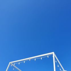 Low angle view of illuminated building against clear blue sky