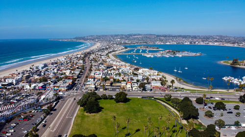 High angle view of cityscape by sea against sky