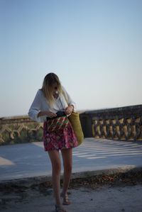 Young woman standing in park