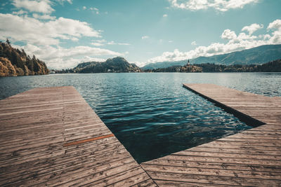 Scenic view of swimming pool by lake against sky
