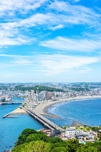 High angle view of buildings by sea against sky