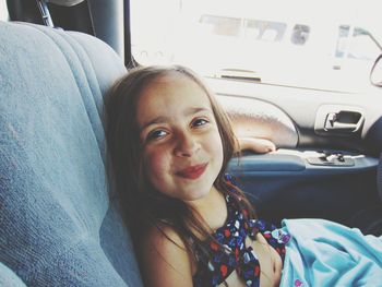 Portrait of smiling young woman in car