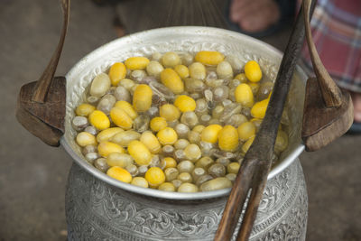 Close-up of silk cocoons in container