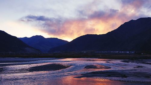 Scenic view of lake against sky during sunset