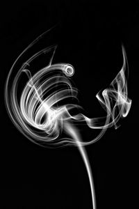 Close-up of smoke over black background