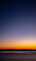 Scenic view of sea against clear sky during sunset