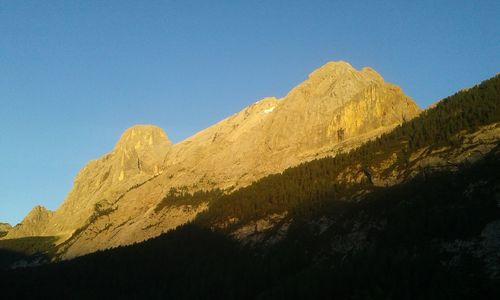 Scenic view of mountains against clear blue sky