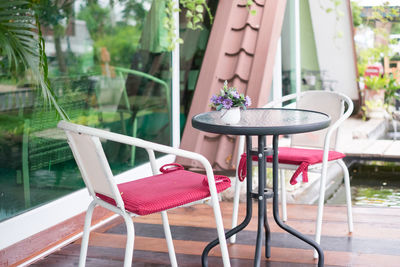 Close-up of empty chairs and table at outdoor restaurant