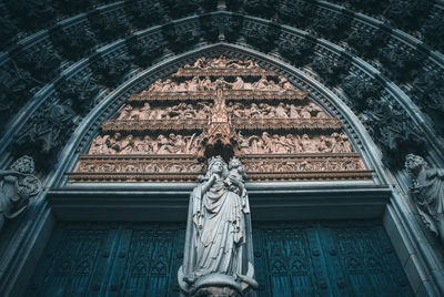 Low angle view of statue against cathedral