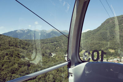 Scenic view of mountains seen through car windshield