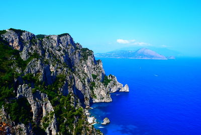 Scenic view of bay against clear blue sky