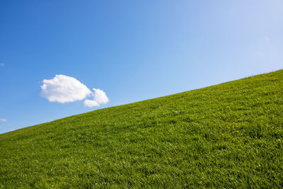 Low angle view of land against blue sky
