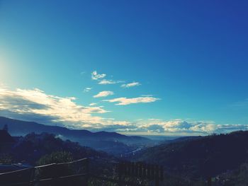 Scenic view of mountains against blue sky