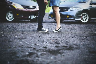 Low section of people walking on road