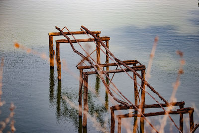 High angle view of abandoned wooden post in lake