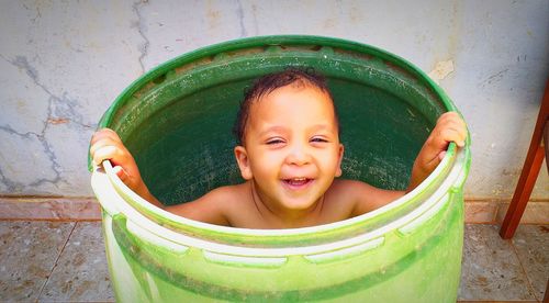 High angle portrait of smiling girl in container