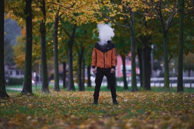 Full length rear view of man walking on road