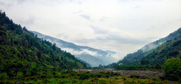 Scenic view of mountains against cloudy sky