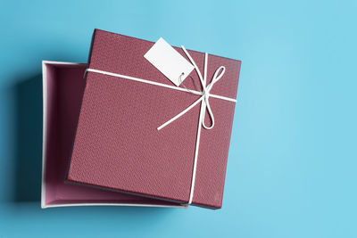 High angle view of gift box over blue background