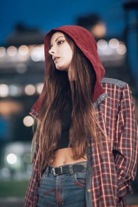 Portrait of a young woman standing outdoors