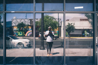 Reflection of man on glass window