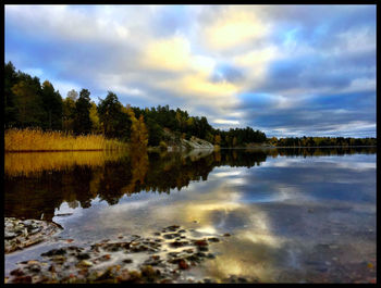 Scenic view of lake against cloudy sky