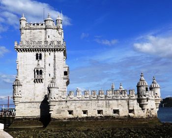Low angle view of belem tower against blue sky