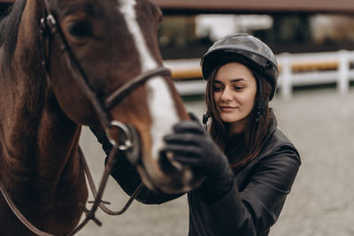 Portrait of young woman riding horse