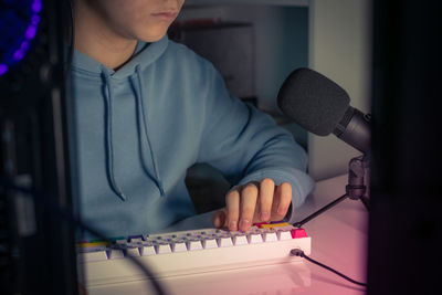 Low section of man playing guitar