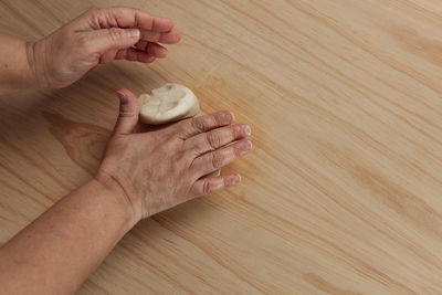 High angle view of people on wooden table