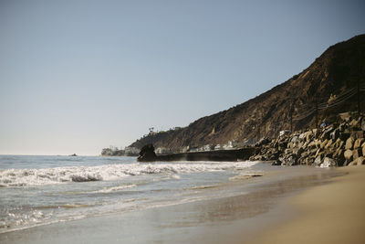 Scenic view of beach against clear sky