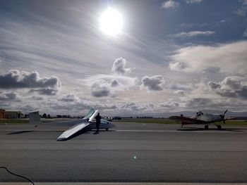 Airplane on runway against sky