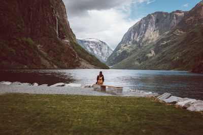 Woman on lake against mountains