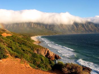 Scenic view of mountains against cloudy sky