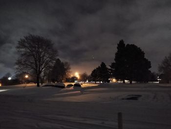 Cars on road against sky at night