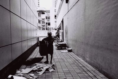 Rear view of woman walking on footpath