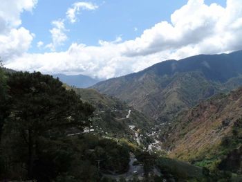 Scenic view of mountains against cloudy sky