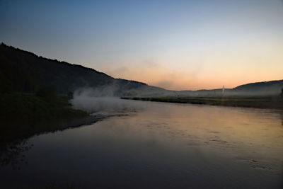 Scenic view of lake against sky during sunset