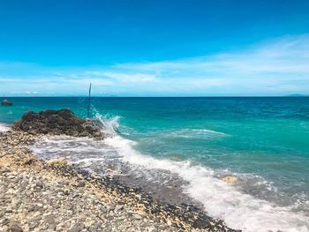 Scenic view of sea against blue sky during sunny day