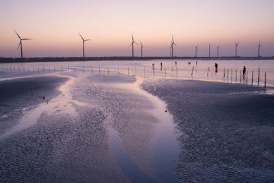 Scenic view of beach against sky during sunset