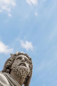 Low angle view of statue against cloudy sky