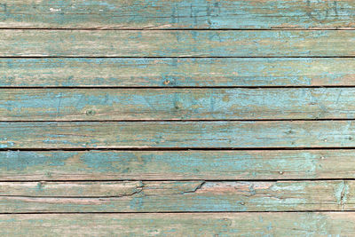 Vintage wooden background with peeling blue paint. texture of old blue wood with natural patterns.