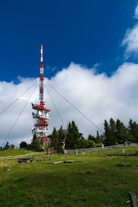 Low angle view of tower on field against sky