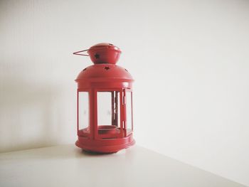 Close-up of red toy on table against wall